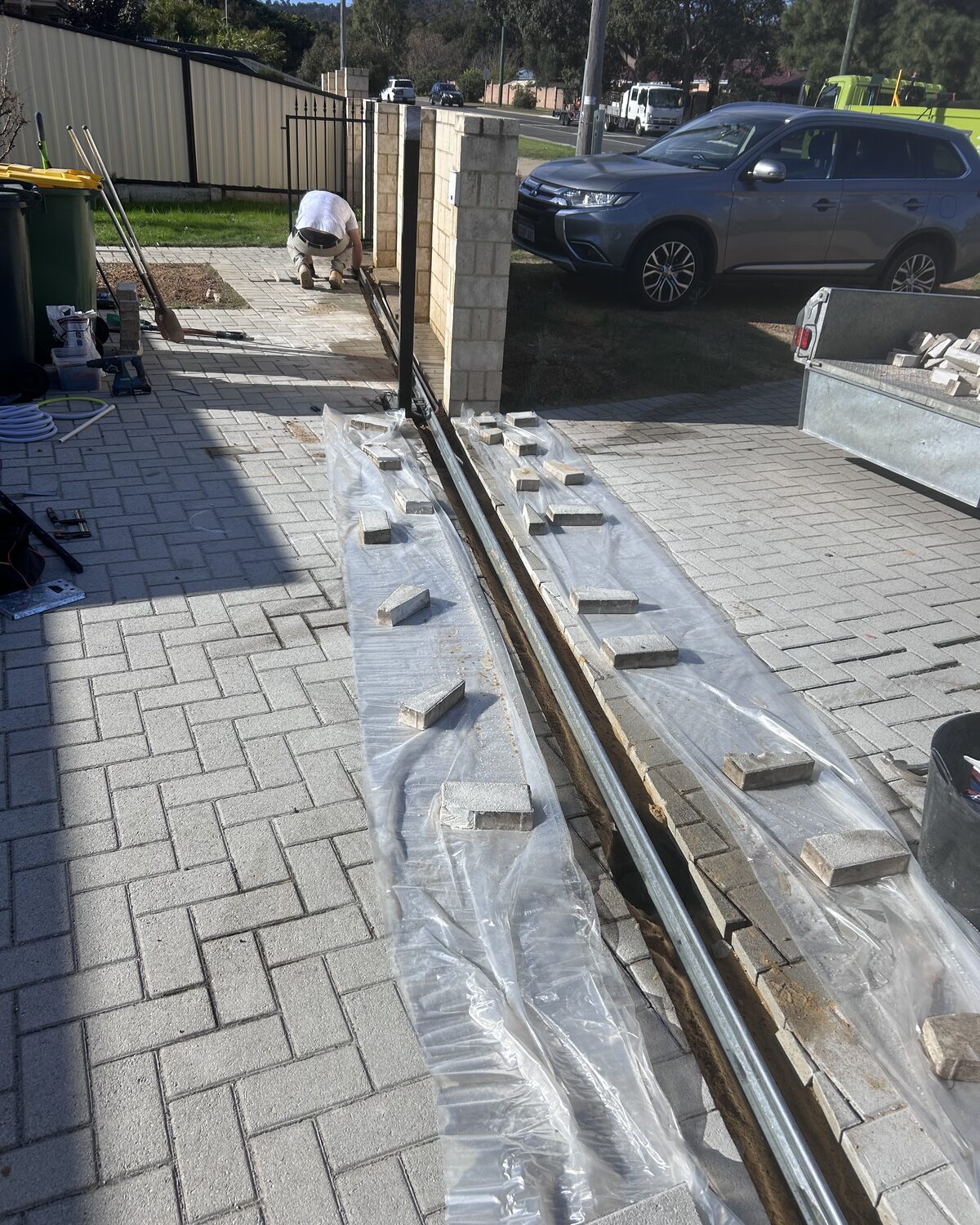 Sliding gate track being installed on a Perth job site